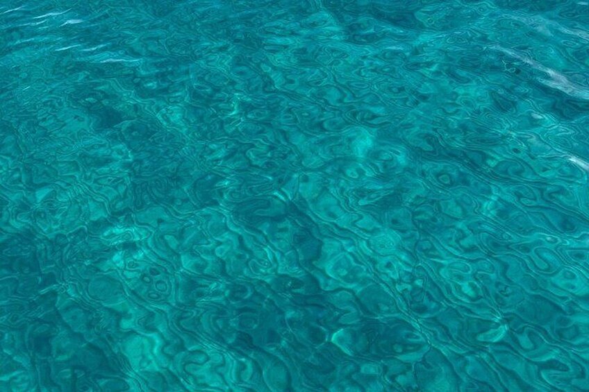 Clear water with visible patterns and ripples. 2