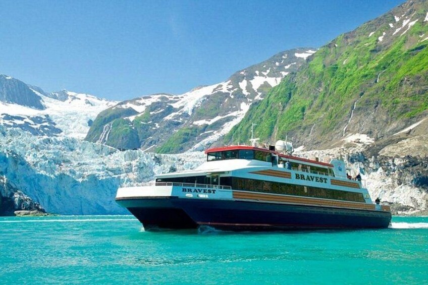 A cruise ship named 'BRAVEST' navigating near a glacier. 3
