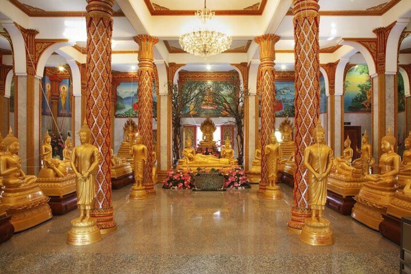 A temple interior with golden statues, columns, and a central altar. 2