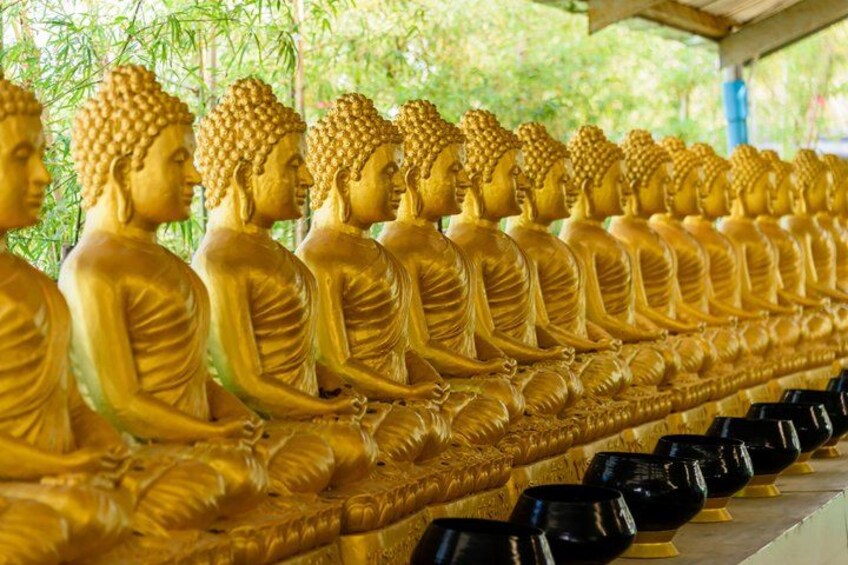 A row of golden Buddha statues in a temple. 2
