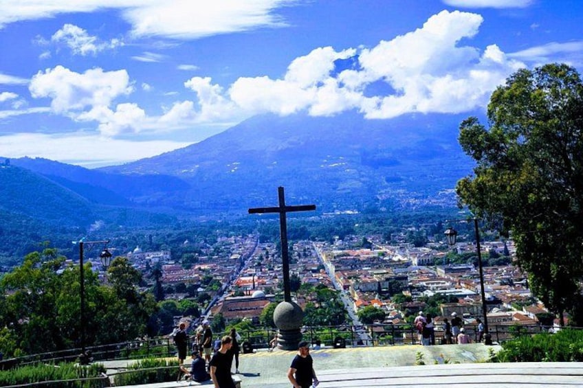 A cross, a cityscape, and a mountain in the background. 4