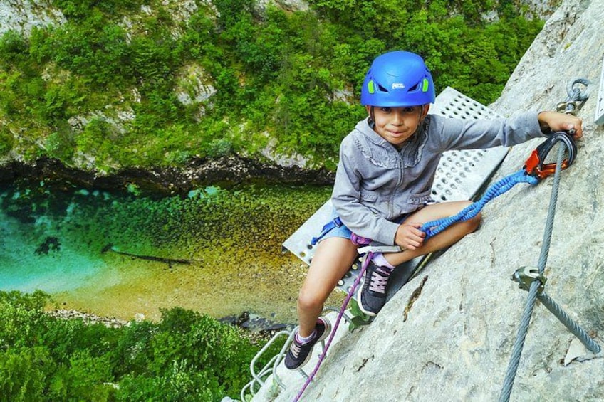 A person climbing a rock face with a rope and harness. 2