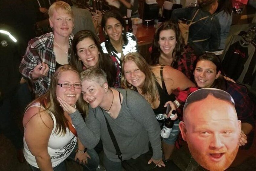 A group of people at a social gathering, possibly a party or event, indoors. 2