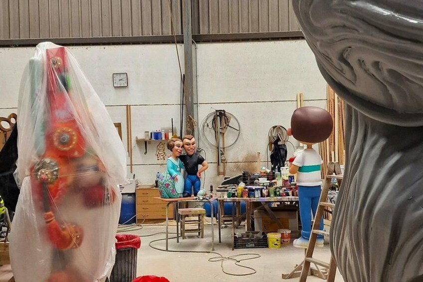 A workshop with people working on sculptures and various tools. 2