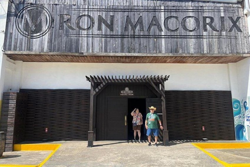 A building with a sign reading 'RON MACORIX' and a wooden facade. 3