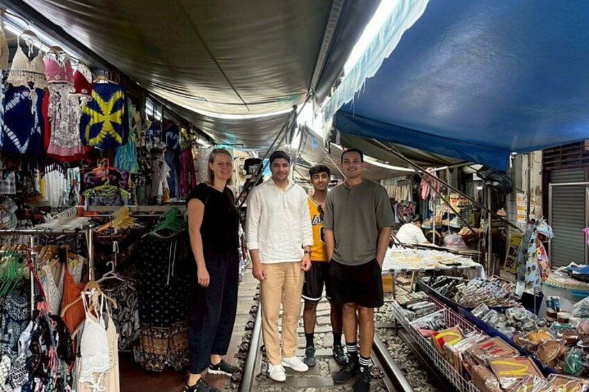 A market with various stalls selling clothes and accessories. 3