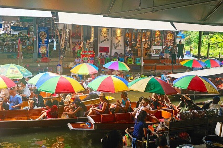 A waterway with boats and colorful umbrellas. 3