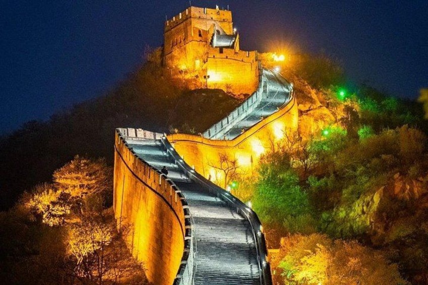 A well-lit section of the Great Wall of China at night, featuring a curved pathway and a watchtower. 1