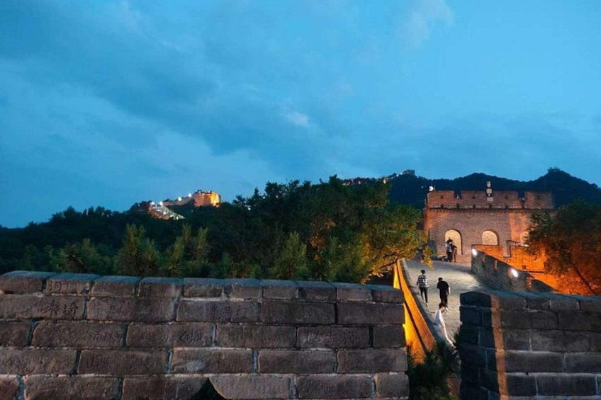 The Great Wall of China at dusk with a view of the city on the hill. 5
