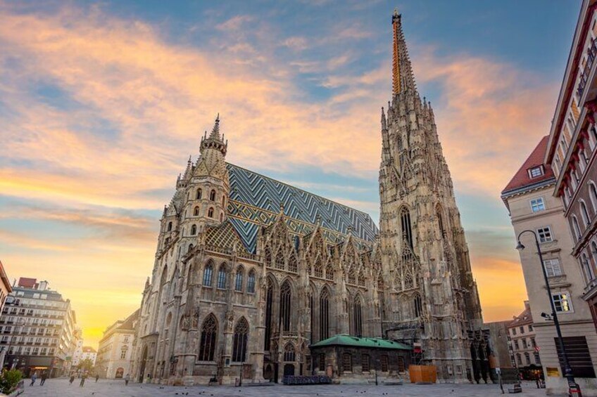 A grand cathedral with intricate Gothic architecture, a prominent spire, and a large green roof. 1