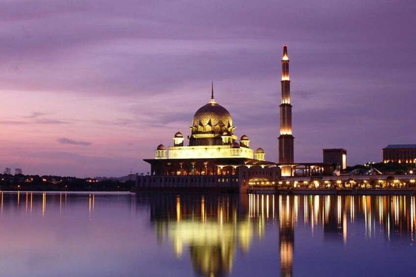 Une mosquée dotée d’un grand dôme et d’un minaret, dont le reflet se mire sur une étendue d’eau calme. 3