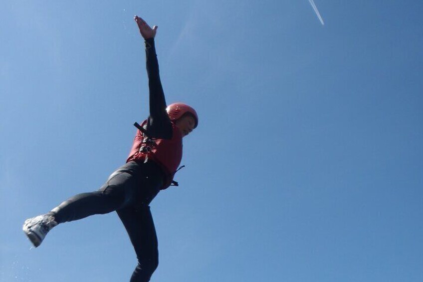 A person skydiving with a parachute. 3
