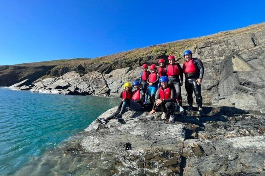 A group of people on a rocky coastal area. 1
