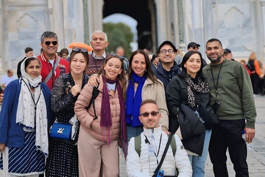A group of people posing in front of a historic building with columns. 5