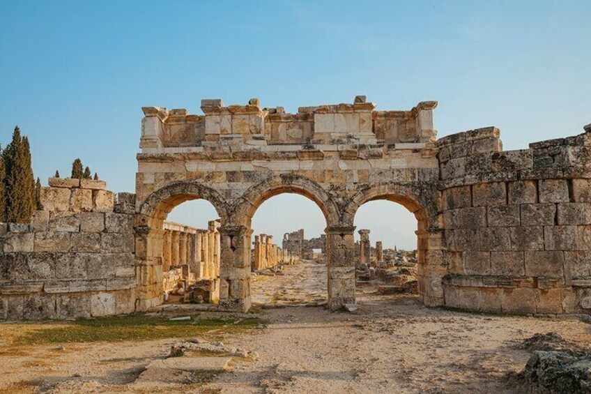 Ancient stone ruins with three large arches. 3