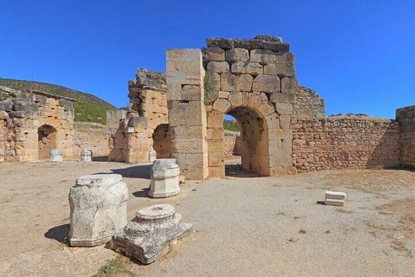 Ancient ruins with stone arches and columns. 5