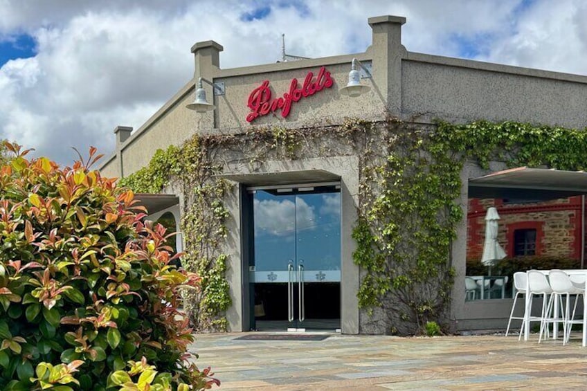 A restaurant named 'Perrins' with a red sign, outdoor seating, and a stone facade. 1