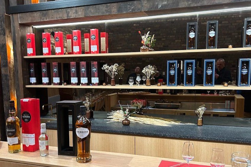 A bar with shelves of liquor bottles and glasses. 2