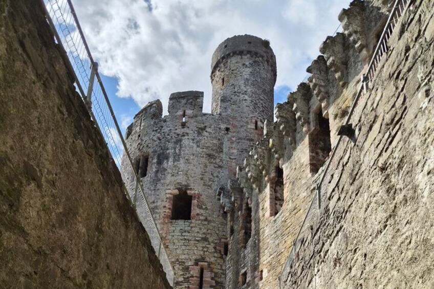A stone castle with a round tower and battlements. 2