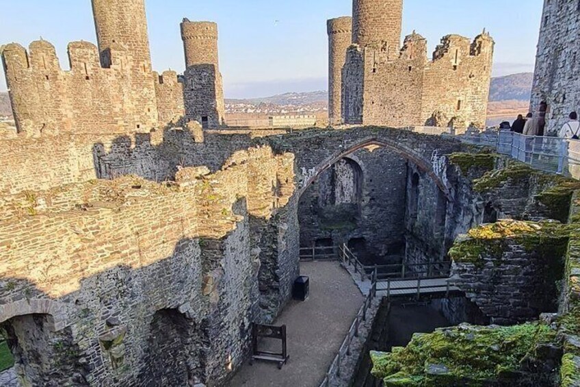 A medieval castle with stone walls, towers, and an arched bridge. 5
