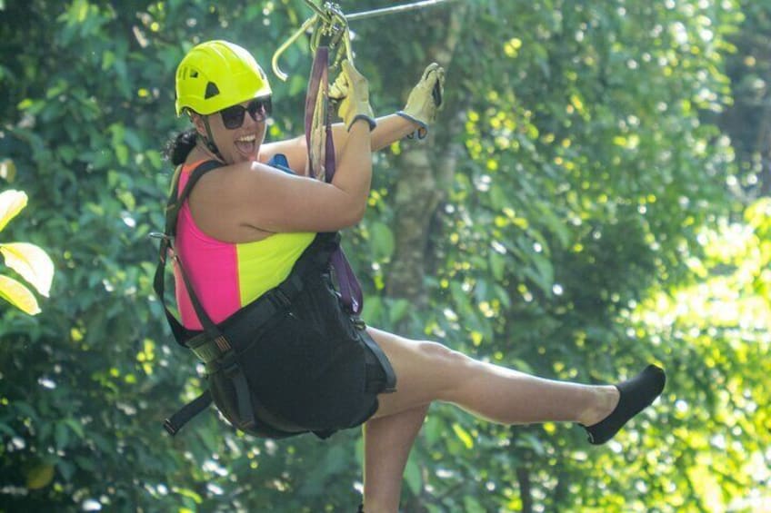 A person zip-lining through a forest. 4
