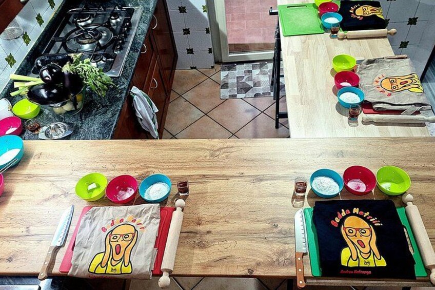 Una cocina con encimeras de madera, cuencos de colores y un paño con motivos de personajes de dibujos animados. 3