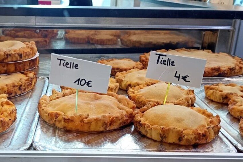 A display of pies with price tags in a bakery. 2