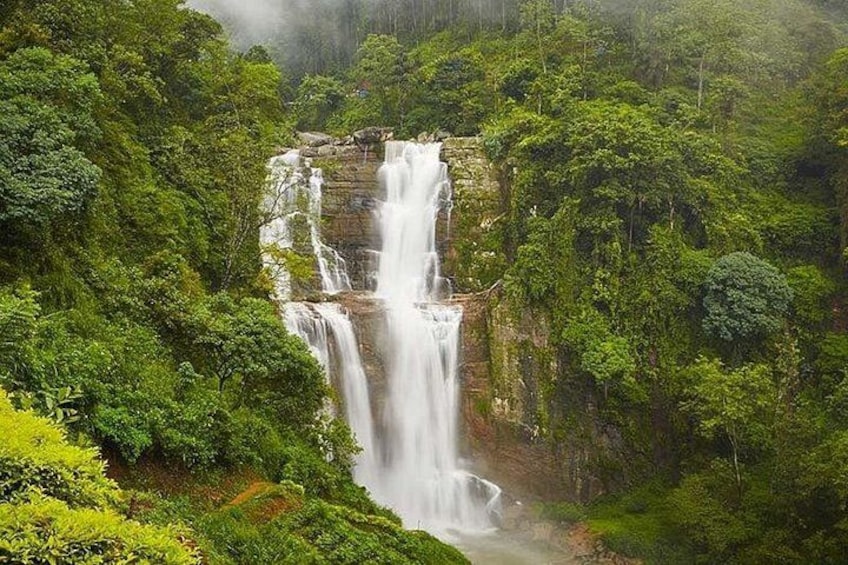 A multi-tiered waterfall surrounded by dense forest. 5