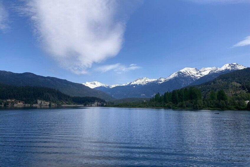 A calm lake surrounded by mountains with snow-capped peaks. 3