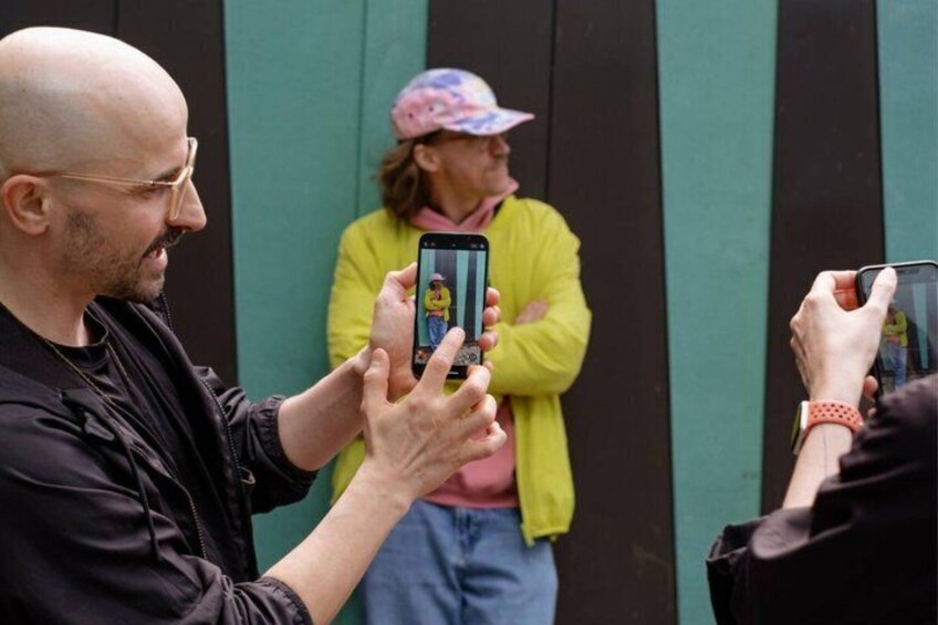 A person holding a smartphone with a cartoon character on the screen. 4