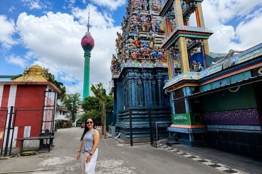 A temple with intricate carvings and a tower in the background. 4
