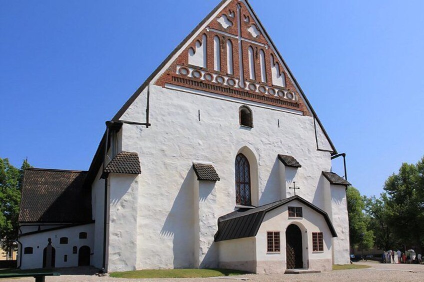 A white church with a red roof and a small annex. 4