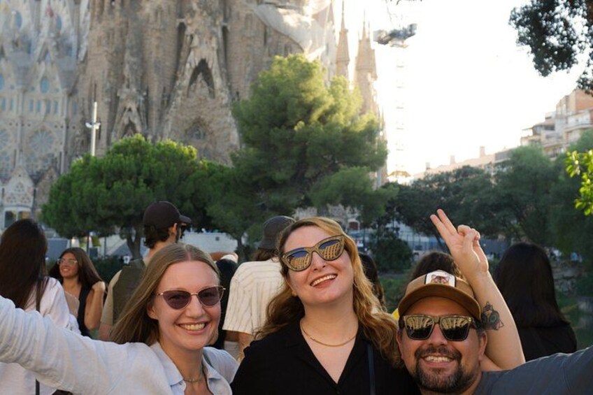 A group of people outdoors with a historic building in the background. 5