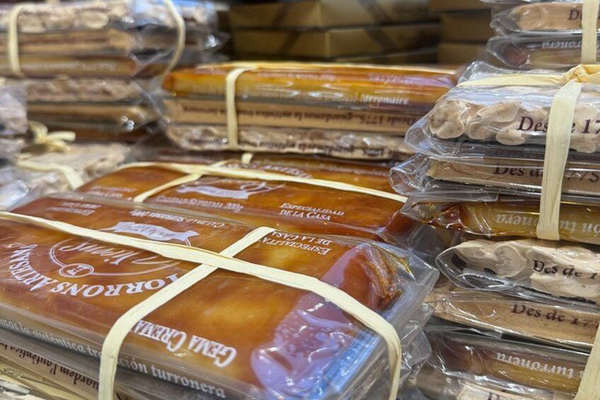 Stacks of packaged food items, likely cheese, with visible text indicating brand and type. 2