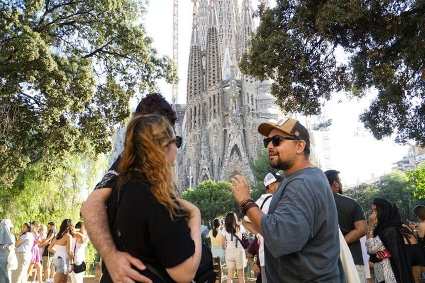 A group of people standing in front of a large, ornate cathedral with intricate architectural details. 4