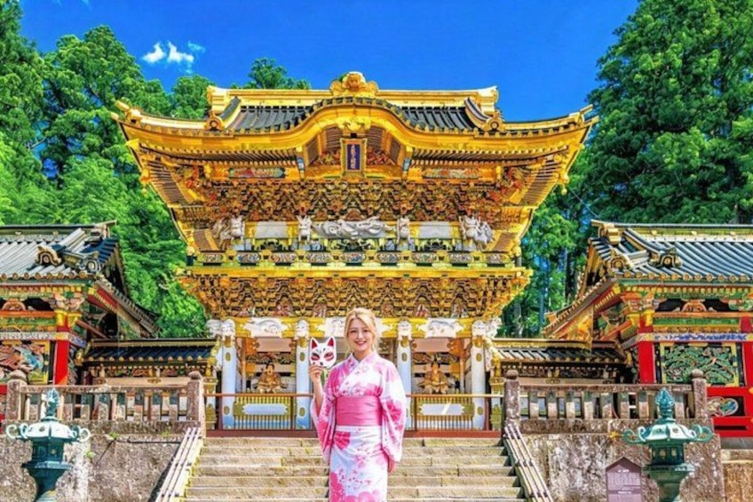 A traditional Chinese building with ornate architecture, a staircase leading up to it, and a person in traditional attire. 2
