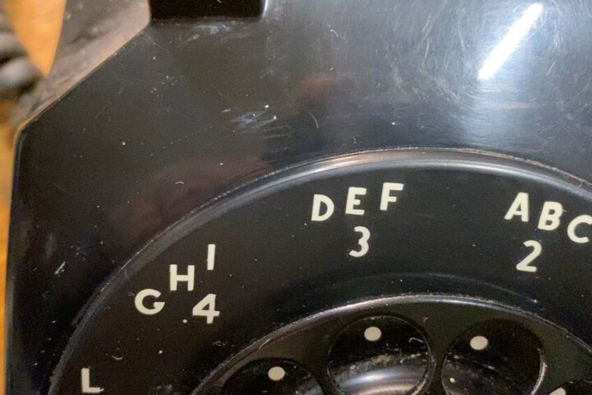 A dial with letters and numbers, possibly part of a machine or device. 4