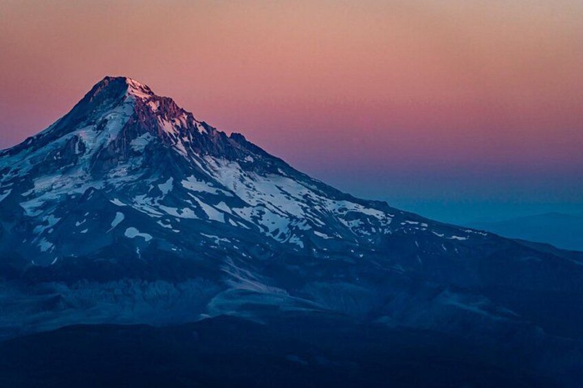 A snow-capped mountain with a clear sky. 4