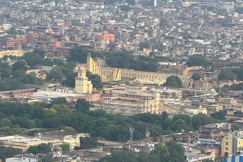A densely populated urban area with a prominent historical building featuring a clock tower. 3