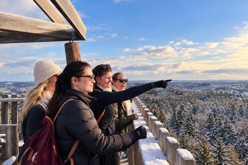 A group of people standing on a wooden platform overlooking a snowy landscape. 2