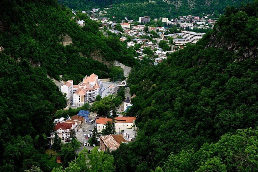 A town nestled in a valley surrounded by dense forest. 2