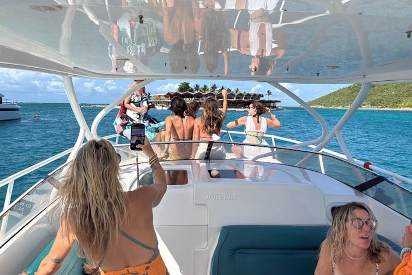 A boat with people on deck, water, and a distant shoreline. 4