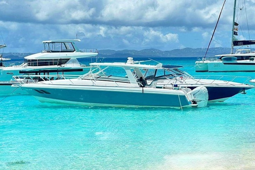A marina with several boats docked in clear turquoise water. 3