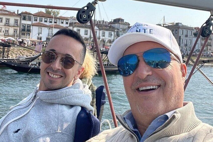 Two people on a boat with a cityscape in the background. 3