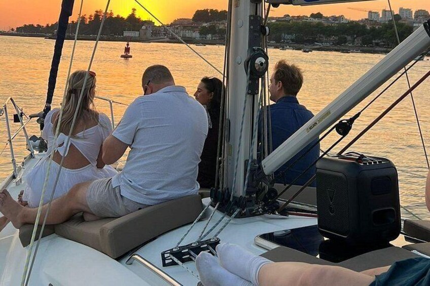 A group of people on a sailboat at sunset. 5