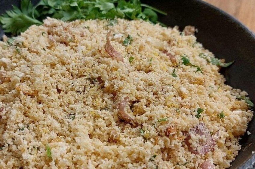 A dish of couscous with herbs and possibly meat. 4