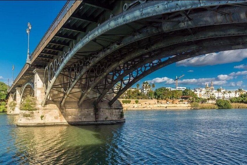 A bridge over a river with a cityscape in the background. 5