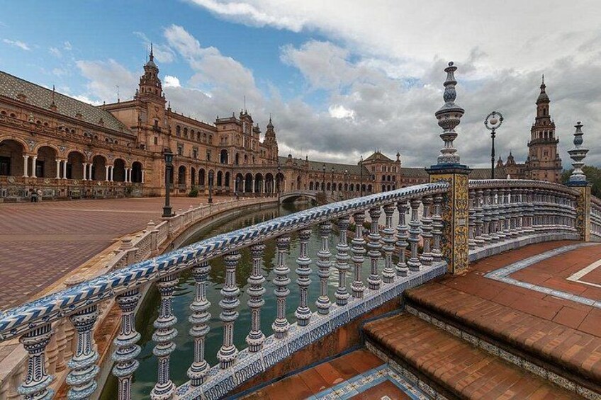 A grand architectural complex with a large courtyard, ornate balustrades, and a reflective water feature. 2