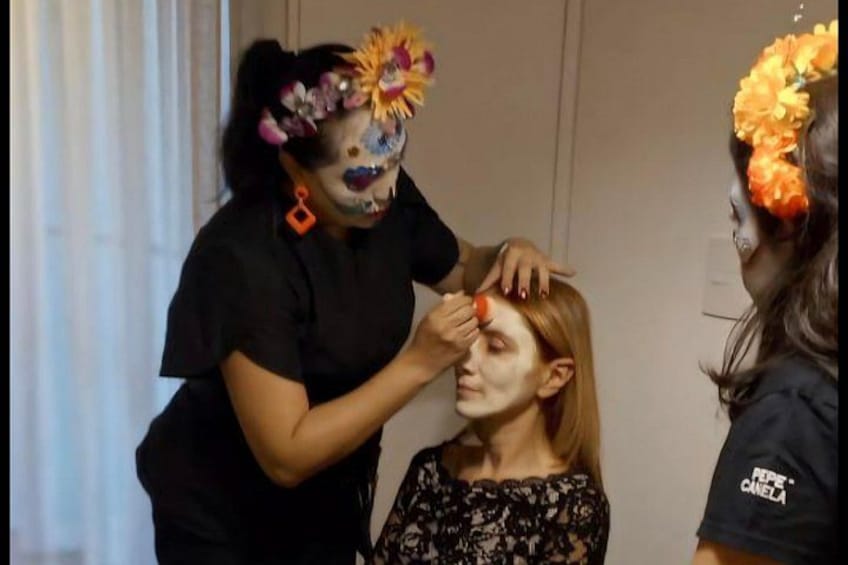 A person applying makeup to another individual. 3