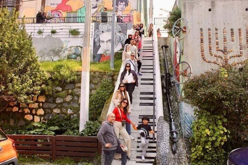 A staircase with people ascending and descending, surrounded by greenery and urban elements. 4